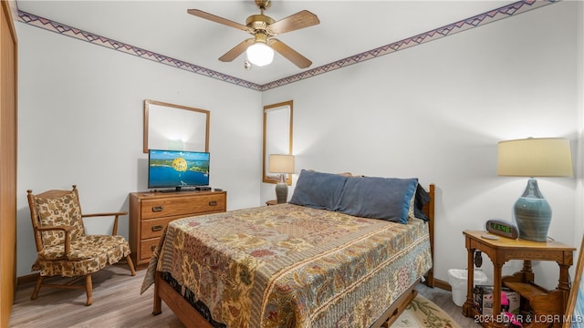 bedroom featuring hardwood / wood-style floors and ceiling fan