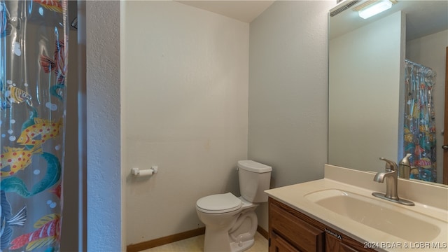 bathroom featuring vanity and toilet