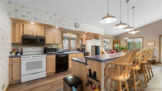 kitchen with dark wood-type flooring, sink, black appliances, decorative light fixtures, and a kitchen island