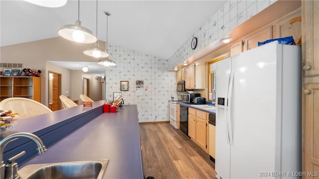 kitchen with light brown cabinetry, light wood-type flooring, sink, black appliances, and hanging light fixtures