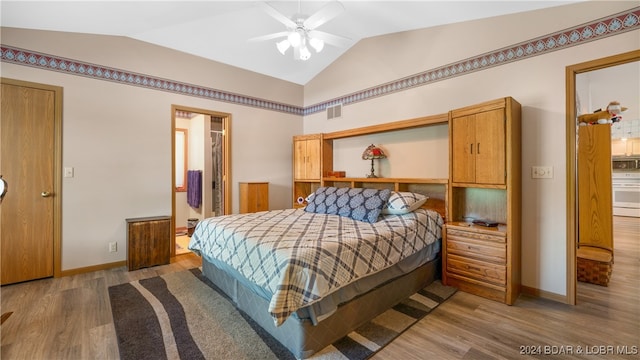 bedroom featuring ceiling fan, vaulted ceiling, and light wood-type flooring