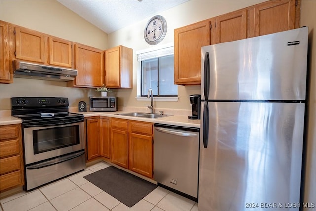 611 Lazy Days Rd Unit C9, Osage Beach, MO 65065 - kitchen with appliances with stainless steel finishes, under cabinet range hood, a sink, light countertops, and light tile patterned floors