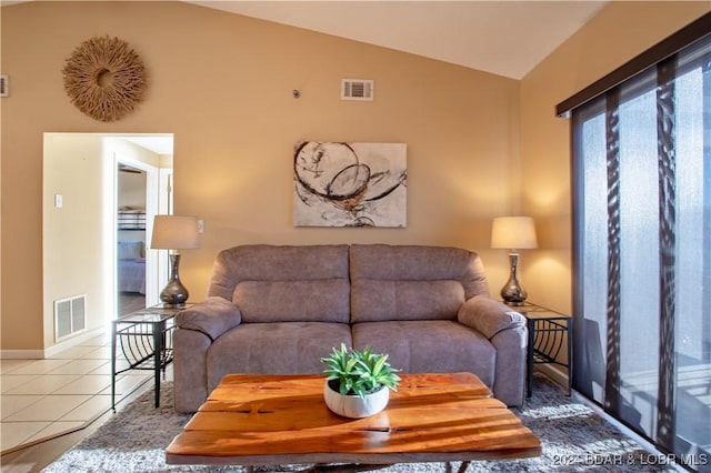 611 Lazy Days Rd Unit C9, Osage Beach, MO 65065 - living area featuring vaulted ceiling, tile patterned flooring, and baseboards