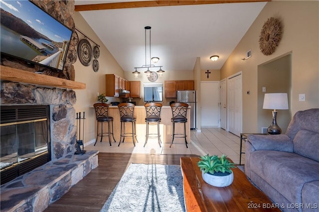 611 Lazy Days Rd Unit C9, Osage Beach, MO 65065 - living area with high vaulted ceiling, a fireplace, light wood-type flooring, and baseboards