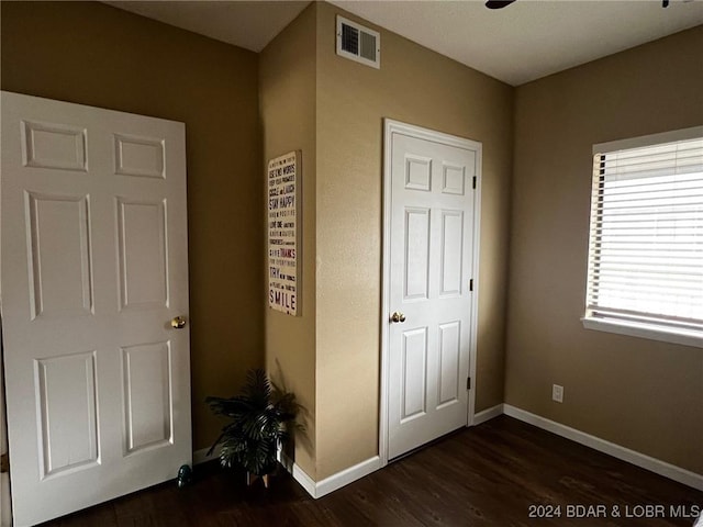 611 Lazy Days Rd Unit C9, Osage Beach, MO 65065 - unfurnished bedroom with dark wood-style flooring and baseboards