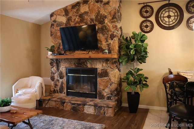 611 Lazy Days Rd Unit C9, Osage Beach, MO 65065 - living room featuring wood finished floors, a stone fireplace, and baseboards