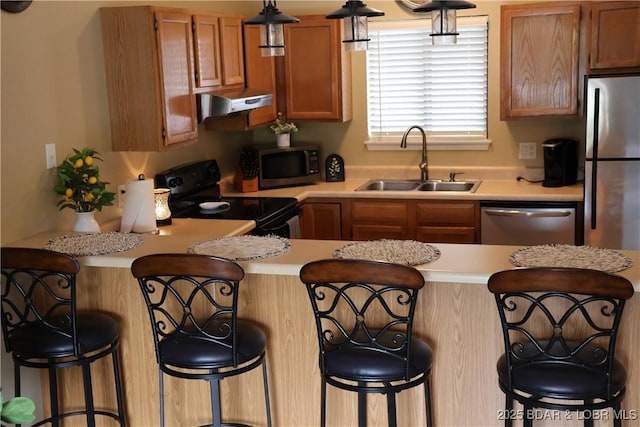 611 Lazy Days Rd Unit C9, Osage Beach, MO 65065 - kitchen featuring appliances with stainless steel finishes, a sink, light countertops, and under cabinet range hood