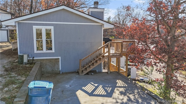 view of property exterior with central AC unit and a patio area