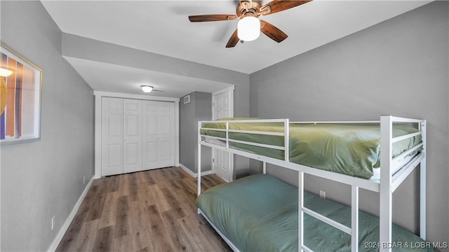 bedroom with a closet, ceiling fan, and hardwood / wood-style floors