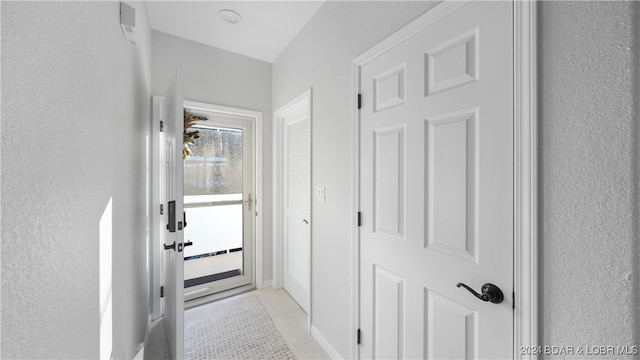 corridor with light tile patterned flooring