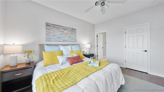 bedroom with ceiling fan and dark wood-type flooring