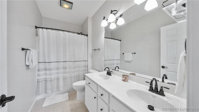 bathroom featuring tile patterned flooring, vanity, and toilet