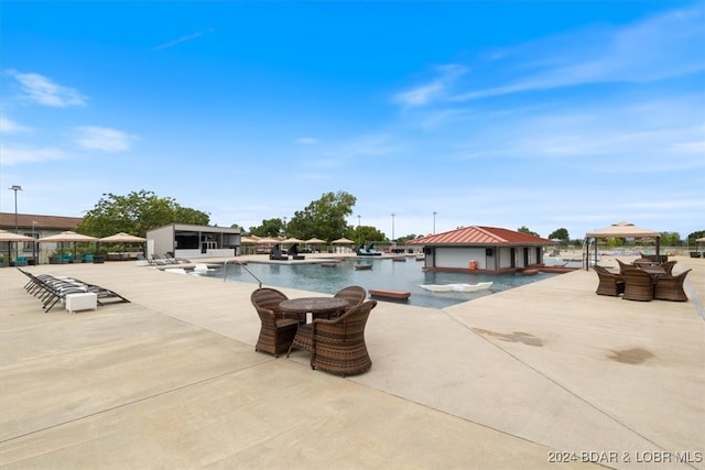 view of pool with a patio, a gazebo, and an outdoor structure