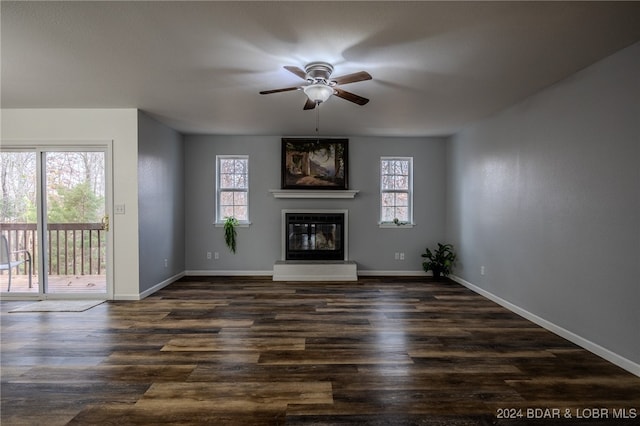 unfurnished living room featuring dark hardwood / wood-style floors, a healthy amount of sunlight, and ceiling fan