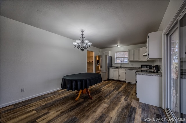 kitchen featuring pendant lighting, sink, appliances with stainless steel finishes, dark hardwood / wood-style flooring, and white cabinetry