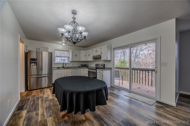 kitchen featuring dark wood-type flooring, an inviting chandelier, white cabinets, sink, and appliances with stainless steel finishes