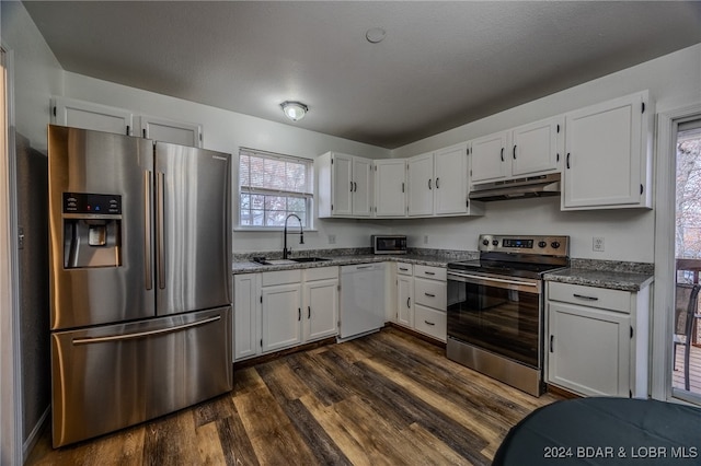 kitchen featuring white cabinets, sink, appliances with stainless steel finishes, and dark wood-type flooring