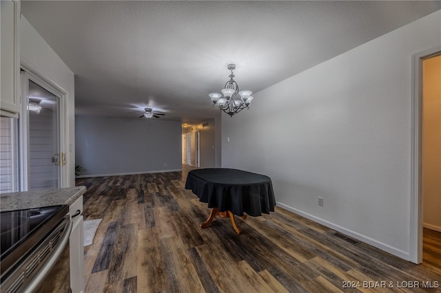 dining room featuring ceiling fan with notable chandelier and dark wood-type flooring