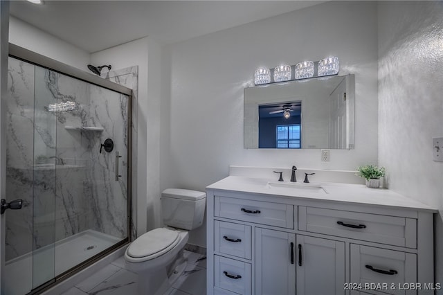 bathroom with vanity, ceiling fan, toilet, and walk in shower