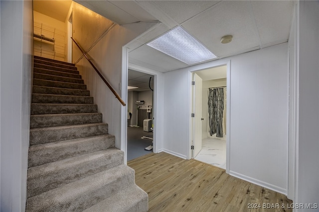 staircase with hardwood / wood-style flooring