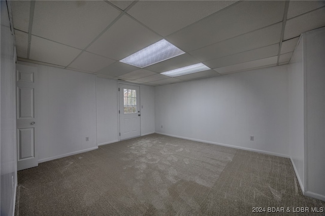 empty room featuring a drop ceiling and carpet floors