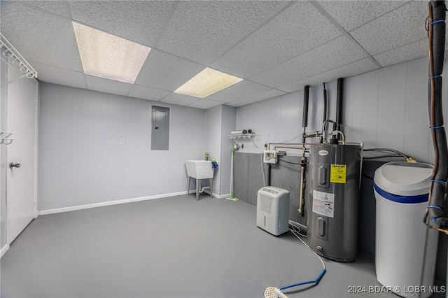 interior space with a paneled ceiling, electric panel, and water heater