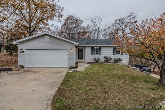 single story home featuring a garage and a front yard