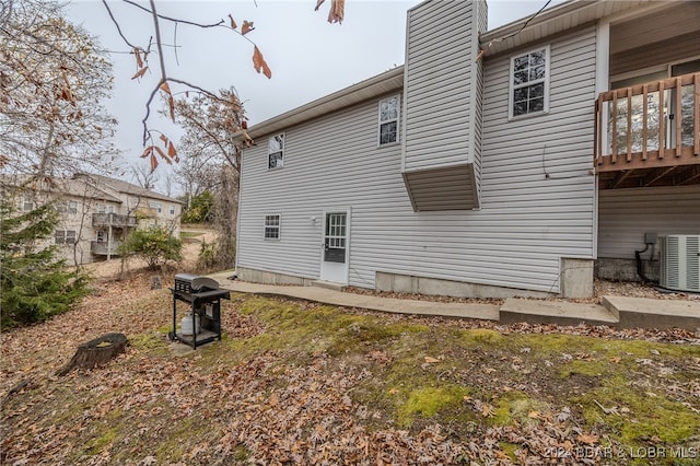 rear view of property featuring central AC unit