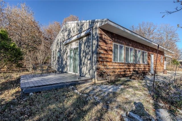 view of side of home with a wooden deck