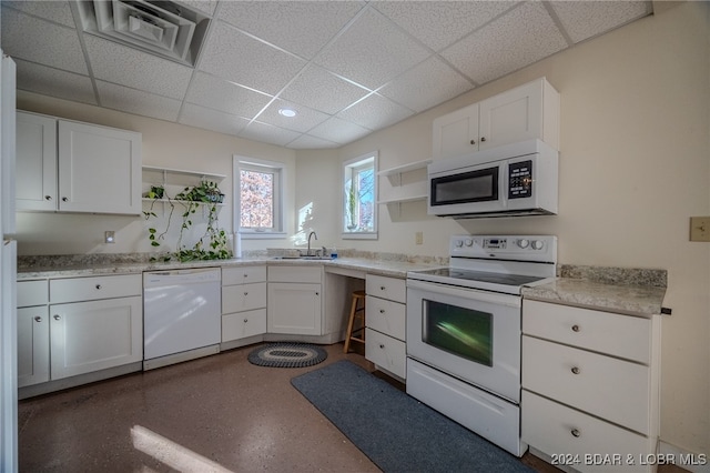 kitchen with white cabinetry, white appliances, and sink