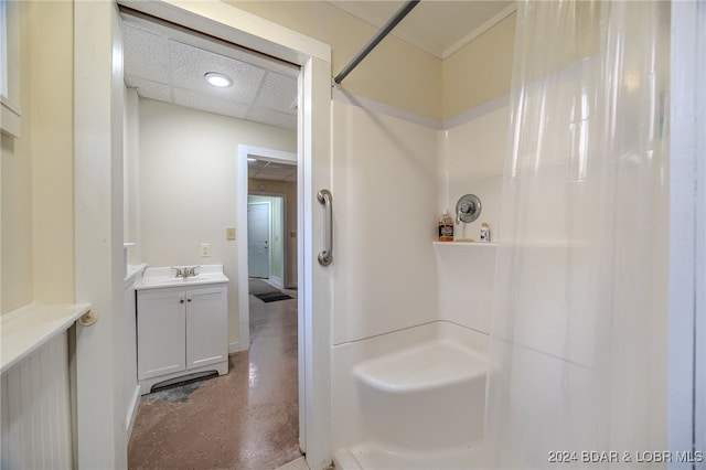 bathroom with a drop ceiling, vanity, and a shower with shower curtain