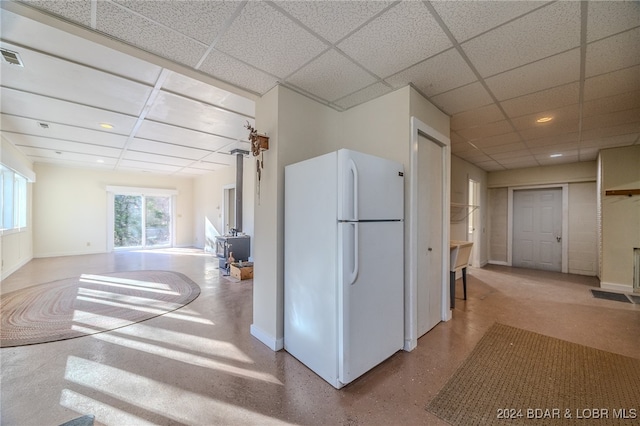 kitchen with a drop ceiling and white refrigerator