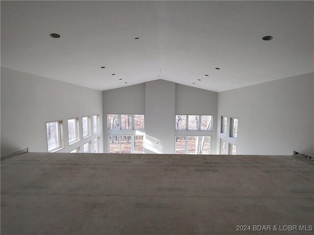 unfurnished room featuring vaulted ceiling