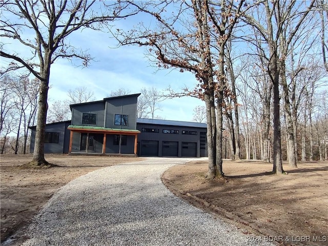 contemporary house with a sunroom, driveway, and an attached garage