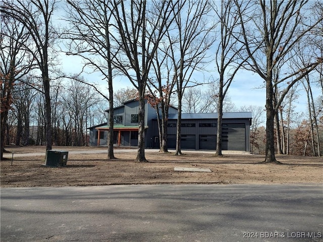 view of front of house featuring a garage and an outdoor structure