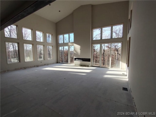 unfurnished living room with a high ceiling