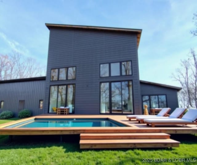 back of house with an outdoor pool