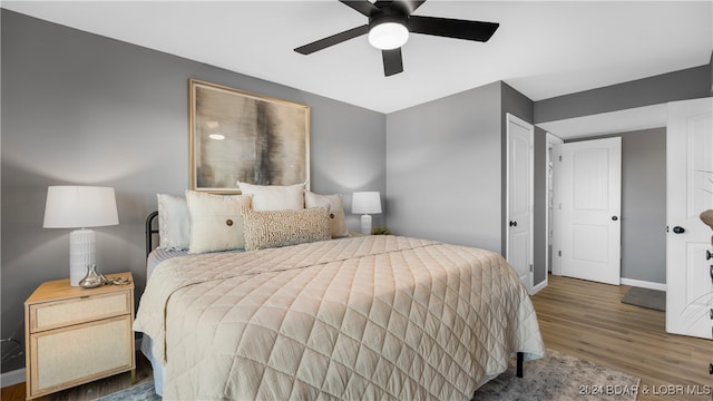 bedroom with wood-type flooring and ceiling fan