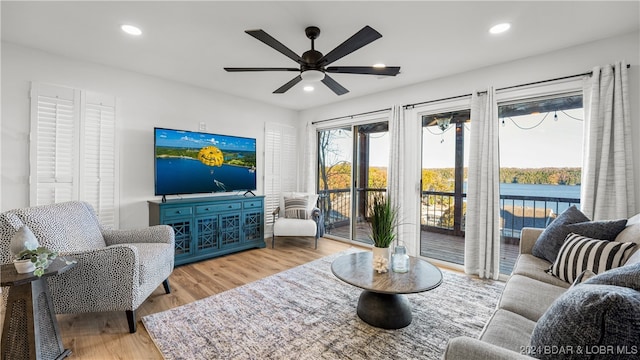 living room with ceiling fan and wood-type flooring