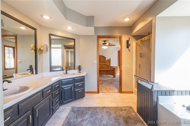 bathroom with vanity, tile patterned flooring, ceiling fan, a textured ceiling, and walk in shower