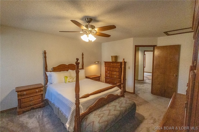 carpeted bedroom featuring a textured ceiling and ceiling fan