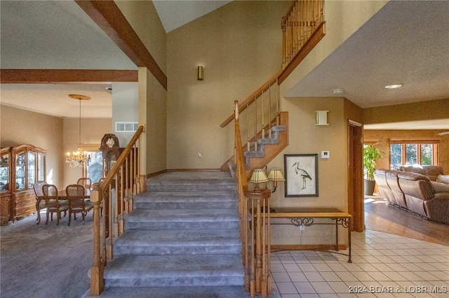 staircase with carpet, lofted ceiling, and an inviting chandelier