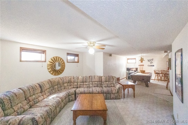 living room with ceiling fan, light colored carpet, a textured ceiling, and pool table