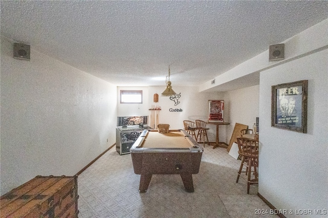 recreation room featuring light colored carpet, a textured ceiling, and pool table