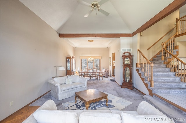 carpeted living room featuring high vaulted ceiling and ceiling fan with notable chandelier