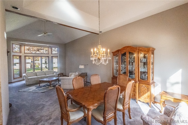 dining space featuring carpet, ceiling fan with notable chandelier, and vaulted ceiling