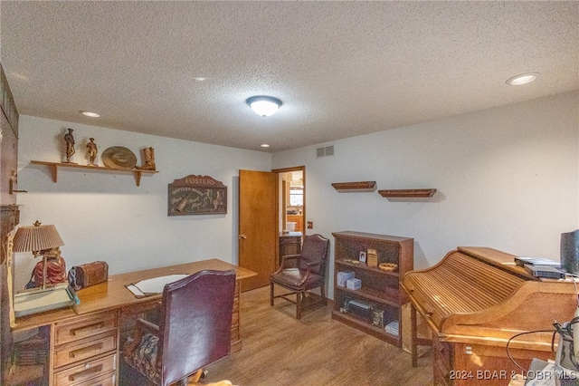 office area featuring hardwood / wood-style floors and a textured ceiling