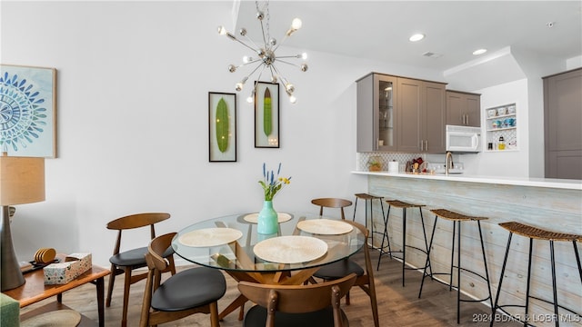 dining area with a notable chandelier and dark hardwood / wood-style floors