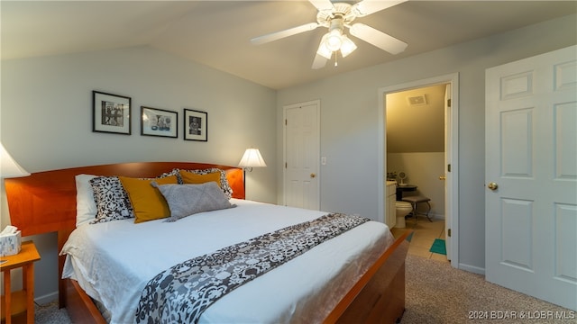 carpeted bedroom with ceiling fan, connected bathroom, and vaulted ceiling