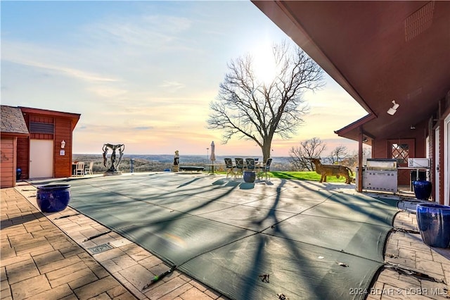 view of patio terrace at dusk